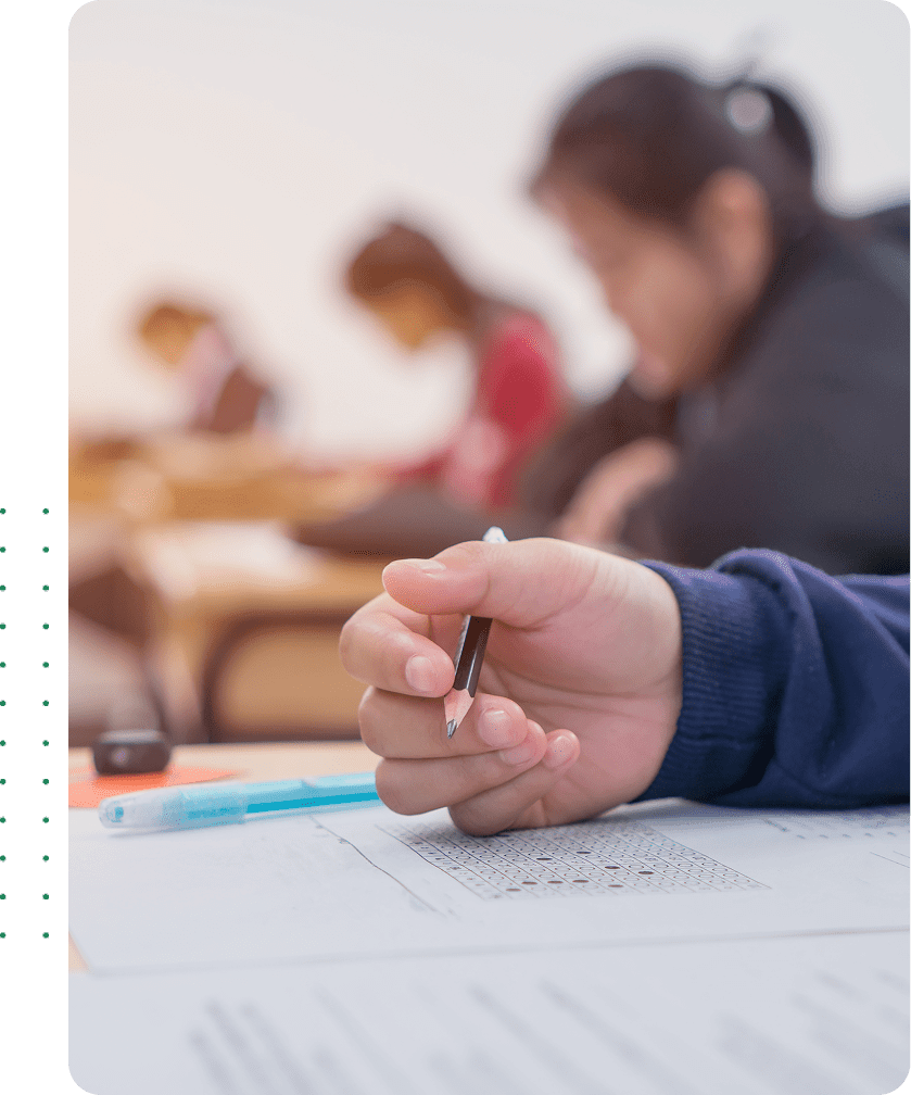 Student taking exam in classroom setting.